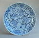 A Chinese dish from the mid Ming Hongzhi period vigorously decorated wth peony scrolls and ornamental rockwork