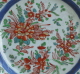 A famille rose Chinese eport plate with carved decoration, dating from the Yongzheng to early Qianlong period, with later English overglaze enamels