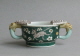 An attractive Chinese cup with leopard handles, decorated on the biscuit with susancai famille verte colours